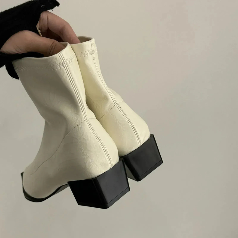 Damen trägt Vintage-Stiefeletten mit spitzer Zehenpartie, stilvoll und wasserdicht für Alltag und besondere Anlässe